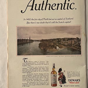 May include: Vintage advertisement for Dewar's White Label Scotch whisky. The ad features a scenic view of Perth, Scotland, and a bottle of whisky with a label. Text includes "Authentic" and "Dewar's White Label."