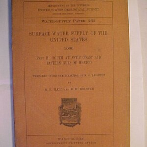 May include: A brown cover of a book titled "Surface Water Supply of the United States 1900" with the text "Part II. South Atlantic Coast and Eastern Gulf of Mexico" and the text "Prepared under the direction of M.G. Leighton by M.R. Hall and B.H. Dolster".