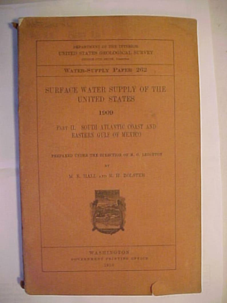 May include: A brown cover of a book titled "Surface Water Supply of the United States 1900" with the text "Part II. South Atlantic Coast and Eastern Gulf of Mexico" and the text "Prepared under the direction of M.G. Leighton by M.R. Hall and B.H. Dolster".