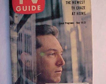 May include: A vintage TV Guide magazine cover featuring a black and white photo of a man with the text "PASSWORD: HOW TO PLAY THE NEWEST TV CRAZE AT HOME" and "Local Programs - May 18-25".