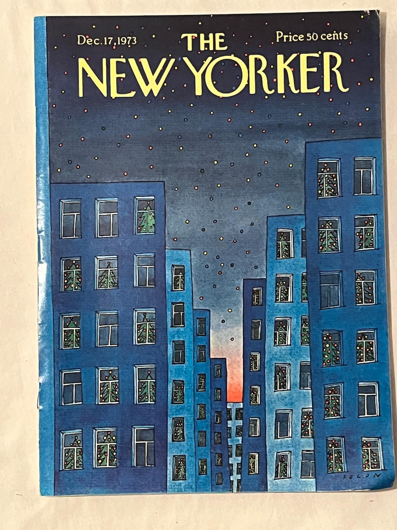 May include: The New Yorker magazine cover from Dec. 17, 1973, featuring blue buildings with Christmas trees in windows under a starry night sky. The magazine title is in yellow, with the price of 50 cents.
