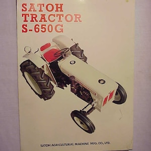May include: A white Satoh S-650G tractor with red accents. The tractor is on a white background with the text "SATOH TRACTOR S-650G" and "SATOH AGRICULTURAL MACHINE MFG. CO., LTD."