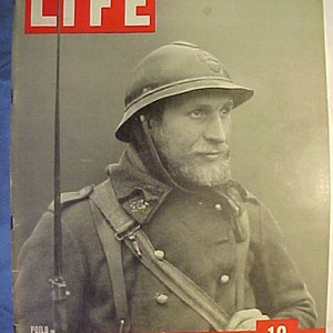 May include: A black and white photo of a soldier wearing a helmet and a uniform. The photo is from a LIFE magazine cover dated March 11, 1940. The magazine cover also says "10 CENTS".