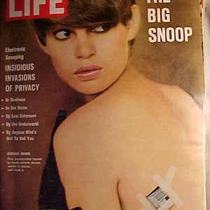 May include: A vintage LIFE magazine cover featuring a woman with short brown hair and the text "THE BIG SNOOP" in large, bold letters. The cover also includes the text "Electronic Snooping" and "INSIDIOUS INVASIONS OF PRIVACY".