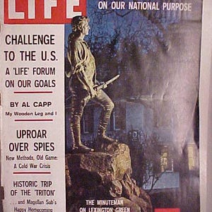 May include: A vintage LIFE magazine cover from May 23, 1960, featuring a black and white photo of a man in a colonial-era outfit standing on a rock. The cover headline reads "A Crucial U.S. Debate On Our National Purpose".
