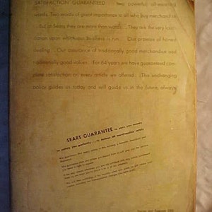 May include: A vintage Sears catalog page with the text "Satisfaction Guaranteed" and "Sears Guarantee" printed in black on a yellowed background. The text explains the company's commitment to customer satisfaction and its long history of providing quality products.