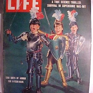 May include: A vintage LIFE magazine cover featuring three young boys dressed in medieval knight costumes, holding swords and shields. The cover text reads "Most Lavish Holiday Buying Ever" and "A True Science Thriller: Survival in Supersonic Bail-Out". The magazine is dated December 19, 1955.