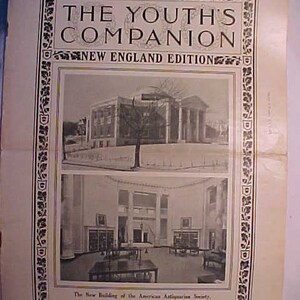 May include: A black and white photograph of the new building of the American Antiquarian Society in Worcester, Massachusetts. The building is a large, two-story structure with a central dome. The photograph was published in The Youth's Companion, a magazine for young people.