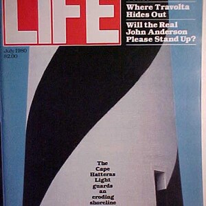 May include: A vintage LIFE magazine cover from July 1980, featuring a black and white abstract design with a blue and white background. The cover text reads "America's Beleaguered Coast", "Where Travolta Hides Out", "Will the Real John Anderson Please Stand Up?" and "The Cape Hatteras Light guards an eroding shoreline".