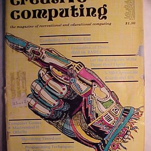 May include: A yellow magazine cover with the title "creative computing" and the text "the magazine of recreational and educational computing". The cover features a colorful illustration of a robotic hand pointing to the left.