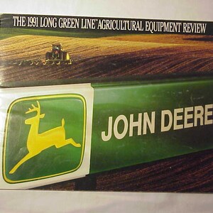 May include: A green and yellow John Deere brochure with a deer logo and the text "THE 1991 LONG GREEN LINE AGRICULTURAL EQUIPMENT REVIEW".