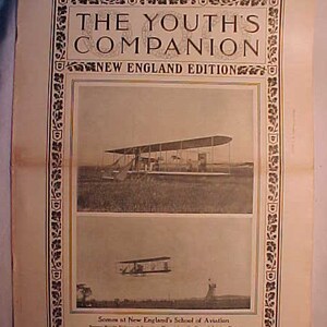 May include: A black and white photo of a vintage magazine cover from August 14, 1911, featuring the title "The Youth's Companion, New England Edition". The cover shows a black and white photo of a biplane in flight, with the caption "Scenes at New England's School of Aviation".