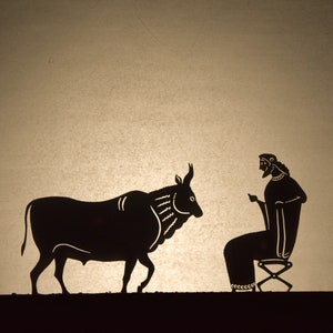 May include: A silhouette illustration depicts a bull facing a seated figure. The bull is black with detailed markings, and the figure is seated on a stool, gesturing with one hand. The background is a light tan color.