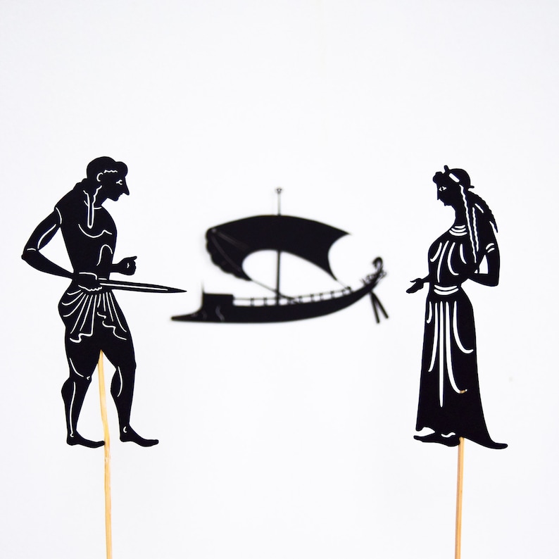 May include: Black silhouette cutouts of a man with a sword, a woman, and a sailboat on a white background. The man is pointing with his right hand. The woman is wearing a long dress. The sailboat has a large sail.