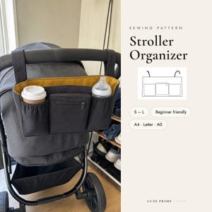 May include: A dark gray stroller organizer with a mustard yellow interior lining, featuring two side pockets and a central zippered compartment. The text reads SEWING PATTERN Stroller Organizer, S-L, Beginner friendly, A4, Letter, A0, and LUXE PRIME.