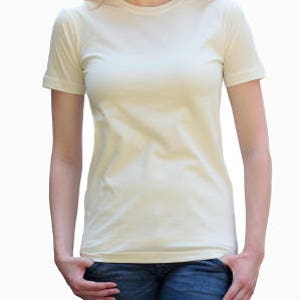 May include: A plain, off-white short-sleeved t-shirt.
