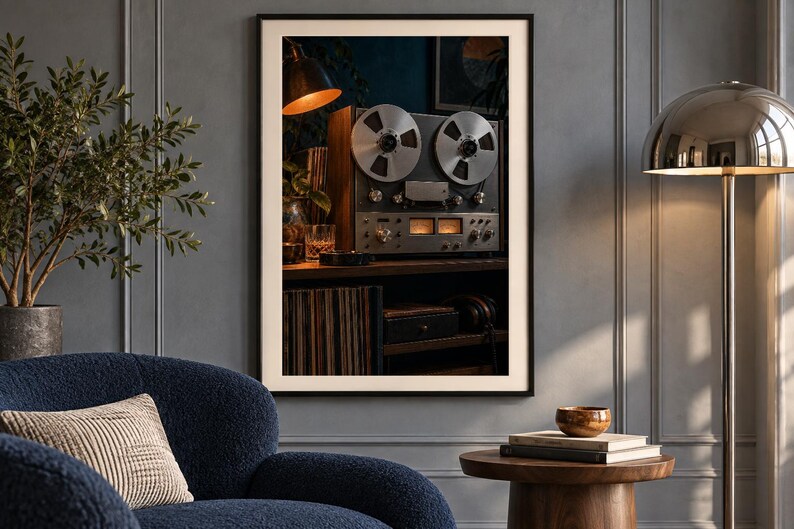 May include: A framed wall art print featuring a vintage reel-to-reel tape recorder with two large silver metal reels, illuminated analog VU meters, and various control knobs, set against a dark background with warm ambient lighting.