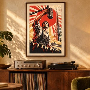 May include: A framed poster featuring a stylized illustration of a person speaking into a microphone before a crowd, set against a large red sun and a radio tower. The artwork uses a bold color palette of red, black, and cream tones.