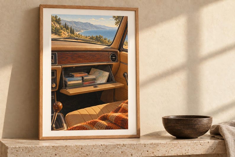 May include: A framed wall art print depicting the interior of a vintage car with an open glove compartment containing small rectangular items and a map, overlooking a coastal mountain landscape through the windshield.
