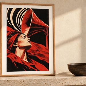 May include: A framed art print featuring a stylized illustration of a person with eyes closed, draped in red fabric, positioned beneath a large red gramophone horn. The background is black with white circular sound waves emanating from the horn.