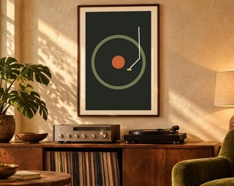 May include: A framed wall art print featuring a graphic illustration of a vinyl record player. The design displays a dark gray background, a muted green circular record, a central orange label, and a white tone arm line.
