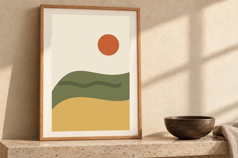 May include: A framed wall art print featuring a cream background with a solid orange circle at the top, a wavy olive green horizontal band in the center with thin black line details, and a solid yellow horizontal band at the bottom.