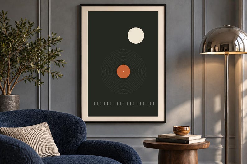 May include: A framed rectangular wall art print featuring a dark charcoal background with a central graphic of a vinyl record in black and orange, a white circle above it, and a row of thin vertical white lines along the bottom edge.
