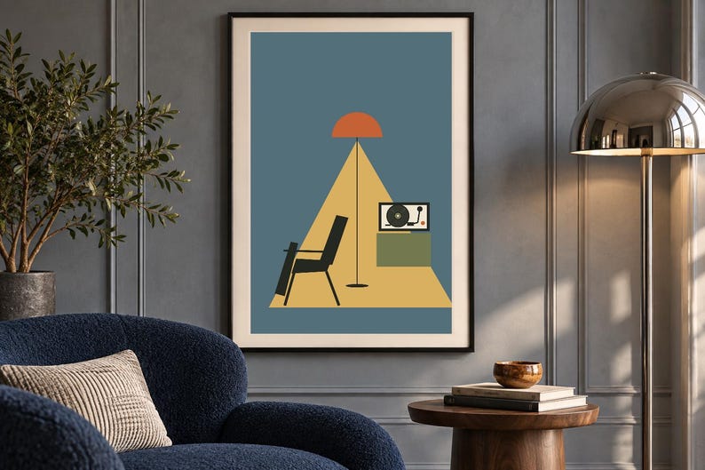 May include: A framed wall art print featuring a blue background with a yellow triangular floor area. The illustration depicts a black chair, a tall floor lamp with an orange shade, and a record player on a green cabinet within the yellow space.
