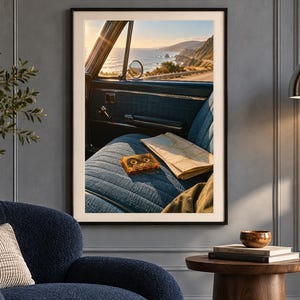 May include: A framed wall art print depicting the interior of a vintage car with blue fabric seats, a cassette tape, and a folded paper map. Through the open window, a coastal highway overlooks the ocean during a golden sunset.