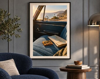 May include: A framed wall art print depicting the interior of a vintage car with blue fabric seats, a cassette tape, and a folded paper map. Through the open window, a coastal highway overlooks the ocean during a golden sunset.