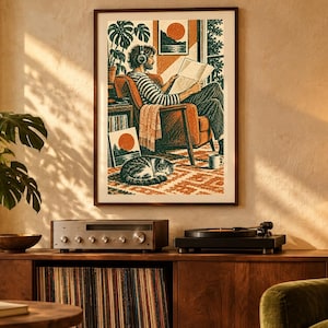 May include: A framed wall art print featuring a stylized illustration of a person wearing headphones, sitting in an orange armchair while reading a newspaper. A cat sleeps on a patterned rug below, with a record player and a houseplant also depicted.