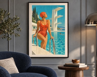 May include: A framed wall art print depicting a person in a red swimsuit and matching swim cap standing at the edge of a bright blue swimming pool. A tall white diving platform stands in the background under a clear sky with cypress trees.