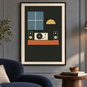 May include: A framed wall art print featuring a dark background with a blue window, a yellow semi-circle, and a record player flanked by two speakers resting on an orange shelf. The composition uses flat shapes and muted colors to depict a scene.