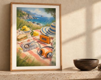 May include: A framed art print depicting a coastal picnic scene on a red and white checkered blanket. The image features a sandwich, a bowl of lemons, a blue and white striped sun hat, an orange portable radio, and wired orange headphones.