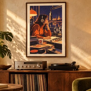 May include: A framed wall art print depicting a person in a rust-colored sweater wearing headphones at a radio broadcast station, with a microphone, mixing console, and reel-to-reel tape recorder, set against a nighttime city skyline backdrop.