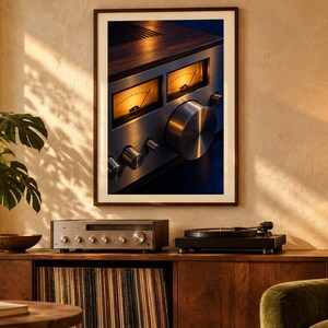 May include: A framed wall art print featuring a close-up of a vintage silver audio receiver with two illuminated amber analog VU meters, a large circular volume knob, and smaller control dials, set against a dark blue and wood-toned background.