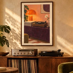 May include: A framed wall art print depicting a warm interior scene with a record player, a stack of vinyl records, a bright orange mushroom lamp, and a single white flower in a glass vase, all set upon a dark purple cabinet against a pink wall.