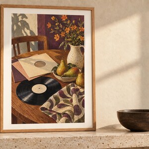May include: A framed art print depicting a still life scene on a wooden table featuring a black vinyl record, stacked record sleeves, a bowl of three green pears, a speckled white pitcher with orange flowers, and a patterned cloth napkin.