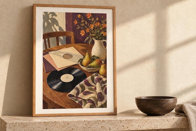 May include: A framed art print depicting a still life scene on a wooden table featuring a black vinyl record, stacked record sleeves, a bowl of three green pears, a speckled white pitcher with orange flowers, and a patterned cloth napkin.