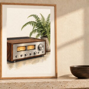 May include: A framed wall art print featuring a watercolor illustration of a vintage audio receiver with a wood grain finish and a silver control panel, positioned next to a potted green fern plant against a light cream background.