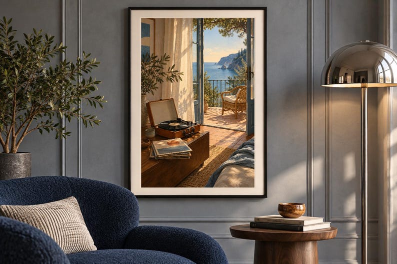 May include: A framed wall art print depicting an open balcony door overlooking a sunny coastal landscape with a record player and a stack of vinyl records on a wooden table in the foreground, set within a room with a blue armchair.