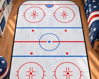 May include: A rectangular area rug featuring a white ice hockey rink design with red and blue markings, including face-off circles, a centre ice circle, blue lines, and red goal lines, finished with a black border around the entire edge.