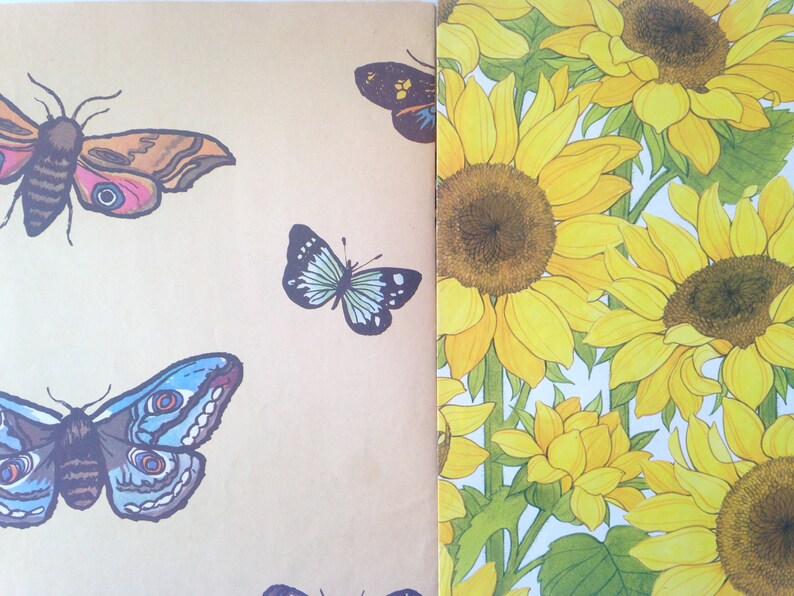 May include: A design featuring illustrations of moths and butterflies in various colours, set against a tan backdrop. Adjacent to this is a pattern of yellow sunflowers with green foliage. The insects display detailed wing patterns.