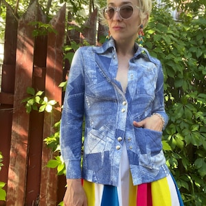 May include: A long-sleeved button-down shirt featuring a blue and white denim-look patchwork print with silver-toned metal buttons and two front pockets, paired with a pleated skirt displaying vertical stripes in yellow, white, pink, and blue.