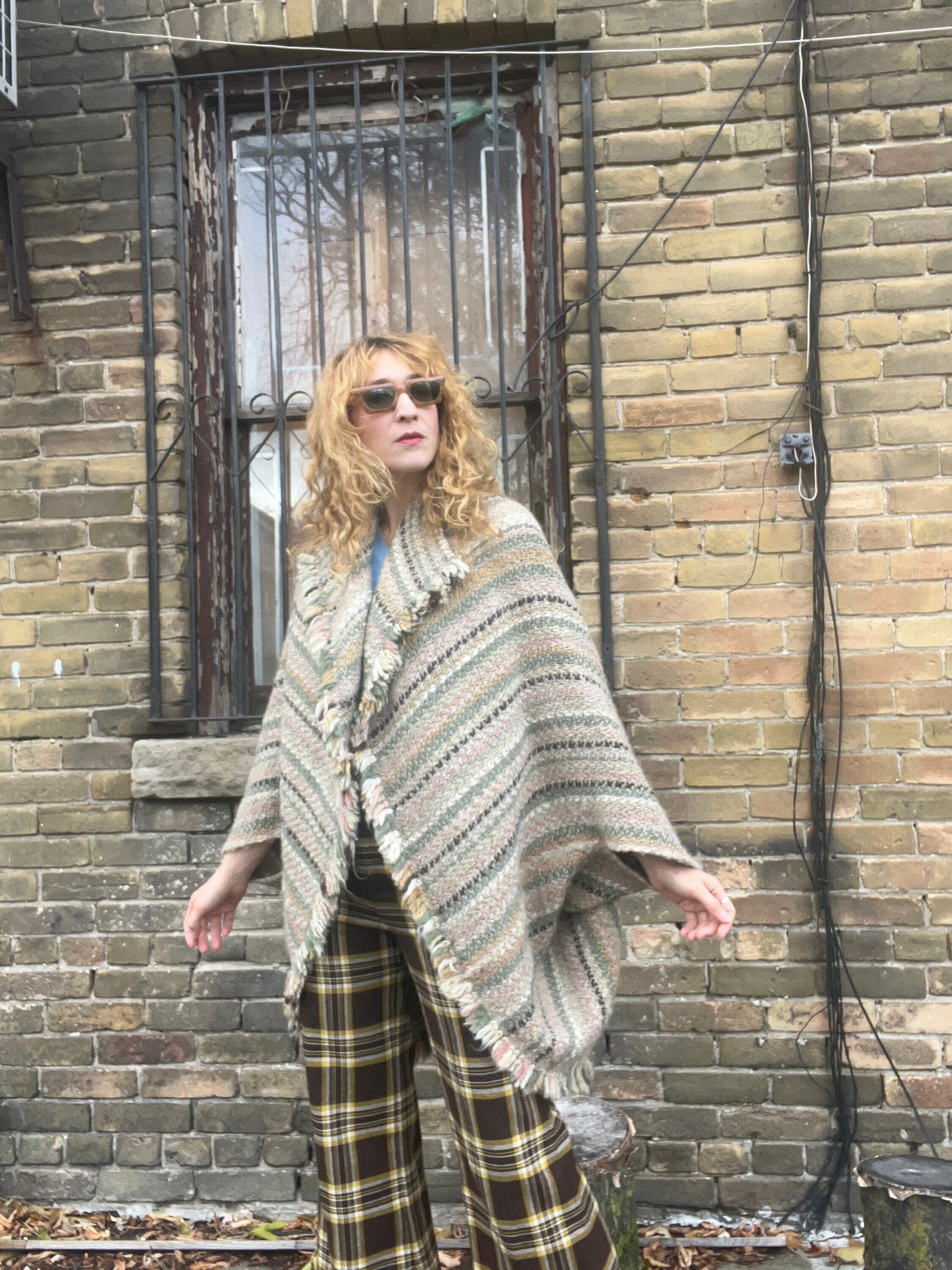 Poncho sweater with store arm holes