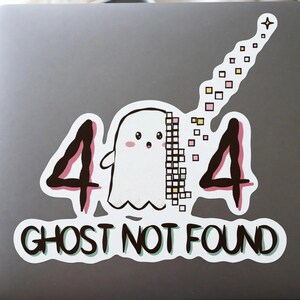 May include: A die-cut sticker featuring a white ghost with pink cheeks positioned between two black numbers four, creating a 404 error design. The ghost is partially pixelated into colorful squares that trail upward. The text GHOST NOT FOUND is below.