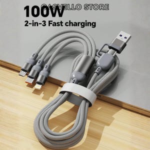 Puede incluir: Un cable de carga trenzado gris con conectores múltiples, tres salidas y una entrada USB-A. El cable incluye una brida blanca y muestra el texto CASVELLO STORE, 100W y 2-in-3 Fast charging. El diseño incluye conectores metálicos.