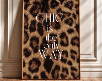 May include: A rectangular wall art print featuring a brown and black leopard print pattern as the background. The white text centered on the print reads, CHIC is the only WAY. The print is enclosed in a thin, light-colored wooden frame.