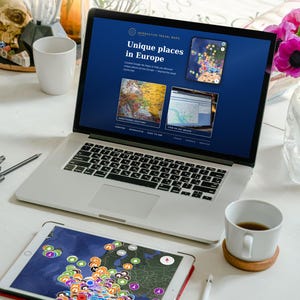 May include: A laptop and tablet displaying an interactive travel map titled Unique places in Europe. The screen shows map pins and location data. Text below lists features including interactive map, one time price, free updates, and instant download.