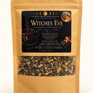 May include: A brown paper pouch containing 50 g of Witches Eve herbal infusion tea. The black label features a full moon, a teacup, and text listing ingredients including black tea, rose petals, ginger, cinnamon, cardamom, clove, and lavender.